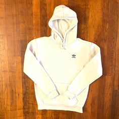 Dope off white color hoodie from the '00s. Embroidered trefoil logo and spellout on left chest. Drawstring hood. Front connector pocket. Has a tiny blemish on the back of the right sleeve but is in great condition otherwise. Fits like a Men's M.  Brand: Adidas Size: M  Color: Cream Condition: Excellent White Cotton Hoodie With Embroidered Logo, Winter Cotton Hoodie With Three Stripes Branding, Casual Adidas Logo Hooded Hoodie, White Sporty Hoodie With Embroidered Logo, Sporty White Hoodie With Embroidered Logo, Casual Adidas Hooded Hoodie, Adidas Logo Cotton Crew Neck Hoodie, Adidas Logo Cotton Hooded Sweatshirt, Adidas Cotton Crew Neck Hoodie