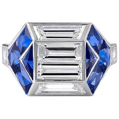 a blue and white diamond ring with three baguetts on the side, set in 18k white gold