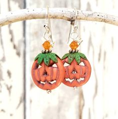 "These adorable little jack o lantern pumpkins will definitely bring you some Halloween cheer. These tangerine orange carved howlite stones are accented with genuine copper hand patinaed green bead caps on top that resemble the stem of the pumpkin. Atop the green leaves sits a sparkly orange Swarovski crystal. They measure 1 1/2\" in length from the top of the sterling silver earwires and 5/8\" in width. **Ready to ship in 3-5 days** See more Halloween and Autumn Earrings here: See more of my je Novelty Orange Earrings For Halloween, Fun Orange Halloween Earrings, Fun Orange Earrings For Halloween, Cute Orange Halloween Earrings, Cute Orange Earrings For Halloween, Halloween Orange Nickel-free Earrings, Nickel Free Orange Halloween Earrings, Nickel-free Orange Earrings For Halloween, Orange Nickel-free Earrings For Halloween