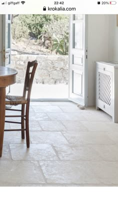 a table and chairs in front of a sliding glass door that leads to an outside patio