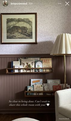 a living room filled with furniture next to a painting on the wall and a lamp