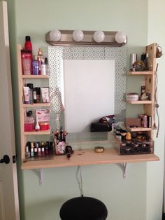 a mirror and shelf in a room with shelves on the wall above it that are filled with beauty products