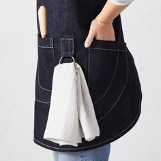 a person wearing an apron with a pocket on the back that has a napkin in it