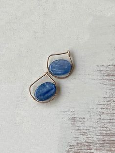 Modern and edgy these gold filled hoops feature blue iridescent kyanite stones. Size is 3/4 of an inch. GOLD-FILLED - 14k Gold filled is considerably durable and considered a lifetime piece of jewelry. This is NOT gold plated or gold dipped vermeil jewelry which can chip off over time with wear. Gold filled metal is essentially a 14k gold tube filled with an inner core metal such as brass and has been mechanically bonded with high very hot heat. It will never chip or flake off such as gold plate Blue Wire Wrapped Hoop Earrings For Everyday, Everyday Blue Wire Wrapped Hoop Earrings, Kyanite Earrings, Gold Filled Hoops, Blue Kyanite, Vermeil Jewelry, Gold Dipped, Modern Earrings, Gold Filled Jewelry