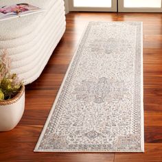 a large white rug is on the floor in front of a door and some potted plants