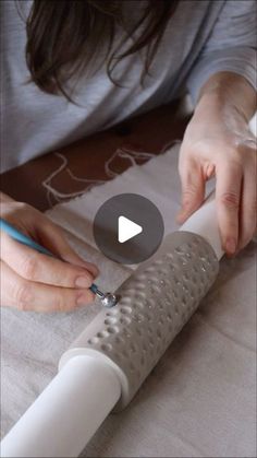 a woman is cutting fabric with a knife