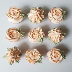 nine cupcakes with frosting flowers on them