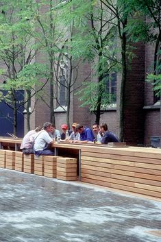 people are sitting on benches in the park