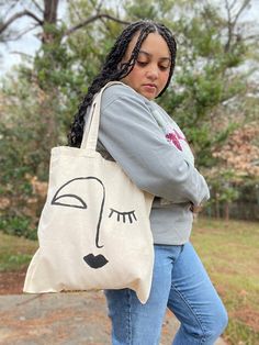 These totes were hand painted by Raven Maureen at her in-home studio. It is a great bag for everyday use - like going to run errands, going to an outdoor Saturday market etc.The tote features an abstract painting on one side of the bag. The tote is a natural canvas color and material.  Here are the specs:  15 inches x 15.5 inches  The model is 5'2'' wearing the tote in the listing.  Straps are 23 inches long each **You must select which option of tote bags that you want to purchase.** Artwork Tote Bag For Artistic Expression, Artsy Hand Painted Canvas Bag For Daily Use, Artsy Hand Painted Canvas Bag For Everyday, Artsy Hand-painted Canvas Bag For Daily Use, Casual Hand Painted Canvas Tote Bag, Canvas Tote Bag With Artwork For Everyday Use, Everyday Tote Bag With Artwork, Artsy Hand Painted Shoulder Bag For Daily Use, Artwork Canvas Tote Bag For Everyday Use