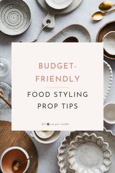 a table topped with plates and bowls next to a sign that says budget friendly food styling prop