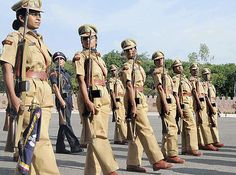 a group of men in uniform walking down the street