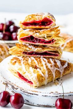 a stack of croissants with cherry filling on top