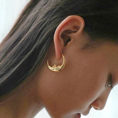 Discover the celestial charm of our Gold Plated Crescent Moon Face Hoop Earrings, designed exclusively for the modern woman. Crafted with meticulous attention to detail, these hypoallergenic earrings offer both elegance and comfort. The real gold plating ensures a luxurious shine that lasts, while the crescent moon face design adds a touch of mystique to your everyday style. Whether for daily wear or special occasions, these earrings are the perfect blend of sophistication and whimsy. Gold Crescent Moon, Celestial Earrings, Face Jewellery, Moon Face, Design Statement, Big Rings, Earrings Simple, Hypoallergenic Earrings, Face Design