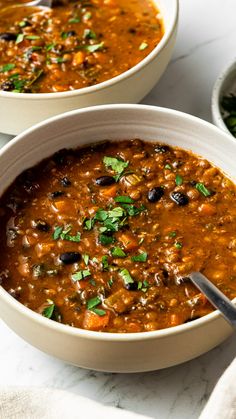 two bowls filled with soup on top of a table