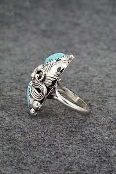 This turquoise and sterling silver ring was made by Navajo silversmith Max Calladitto. The inside of the band is signed and stamped sterling.Size: 5.5Length: 1"Width: 5/8"Free shipping on all orders! We ship with USPS and always include tracking. All orders ship within a day of payment.Returns are accepted up to 30 days after you receive your order. Just send us a message. Our shop offers cash back or store credit. The item must be returned in new condition. Southwestern Sterling Silver Turquoise Ring For Anniversary, Unique Silver Turquoise Ring With Inlay, Southwestern Turquoise Ring In Sterling Silver, Southwestern Untreated Turquoise Sterling Silver Ring, Untreated Southwestern Turquoise Sterling Silver Ring, Vintage Sterling Silver Turquoise Ring With Inlay, Southwestern Sterling Silver Oval Rings, Unique Nickel-free Turquoise Ring For Anniversary, Southwestern Sterling Silver Turquoise Ring