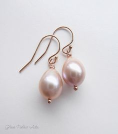 "Genuine champagne pink freshwater pearl earrings ~ 100% sterling silver, 14k gold fill or rose gold fill ~ Shimmery genuine freshwater pearls - Choose your size ~ Total earring dangles just about 1 1/4 - 1 1/2 inches long (35mm) ~ Ear wires are sterling silver, 14k gold fill or rose gold fill ~These earrings are handmade, made to order, and packaged for you See our matching champagne pearl items: https://www.etsy.com/listing/225858095/champagne-pearl-necklace-pink-pearl https://www.etsy.com/lis Rose Gold Dangle Pearl Earrings In Sterling Silver, Rose Gold Sterling Silver Dangle Pearl Earrings, Classic Pink Drop Jewelry, Rose Gold Teardrop Pearl Earrings For Anniversary, Delicate Hypoallergenic Rose Gold Pearl Earrings, Pink Teardrop Pearl Earrings For Wedding, Rose Gold Teardrop Pearl Earrings As Gift, Rose Gold Teardrop Pearl Earrings With Ear Wire, Elegant Pink Teardrop Pearl Earrings