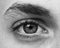 a man's eye is shown in black and white