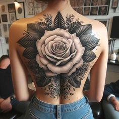 a woman with a rose tattoo on her back