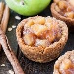 apple pies with cinnamon and apples in the background