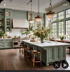 a kitchen filled with lots of green cabinets and counter top next to a stove top oven