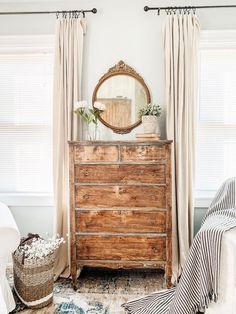 a bedroom with a dresser and mirror in it