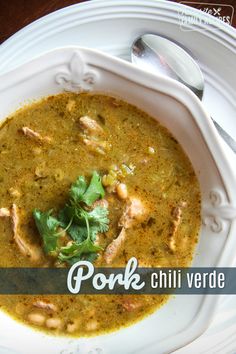 a white bowl filled with soup and garnished with cilantro