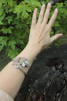 ITEM DESCRIPTION: Bracelet length 26 cm (10 inches) standard woman size, adjustable, width 4 cm (2inches). Weight - 14 g. I made this plant bracelet of sterling silver and peridot. But you can choose another stone. Please write to me to the conversation to discuss your custom order. The bracelet is highly detailed to recreate a natural object. There is a texture on the leaves and small berries. The botanical bracelet looks very elegant and unusual. It will be a great gift for nature lovers and a Adjustable Nature-inspired Bracelets, Adjustable Sterling Silver Bracelet For Wedding, Adjustable Sterling Silver Wedding Bracelet, Nature-inspired Adjustable Silver Cuff Bracelet, Nature-inspired Sterling Silver Bracelet Jewelry, Adjustable Silver Nature-inspired Cuff Bracelet, Nature-inspired Sterling Silver Bracelet, Adjustable Nature-inspired Bracelet Jewelry, Adjustable Nature-inspired Jewelry Bracelet