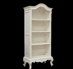 a white bookcase with three shelves on it