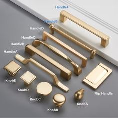 an assortment of handles and knobs on a gray surface