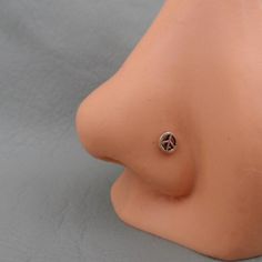 a close up of a fake breast with a diamond ring on it's side