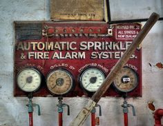 an old sign on the side of a building that says automatic sprinkle and fire alarm system