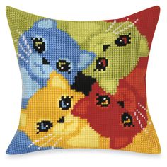 a cross stitch pillow with four cats on it