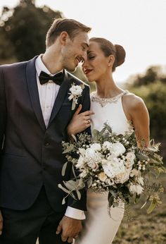 a bride and groom pose for a wedding photo