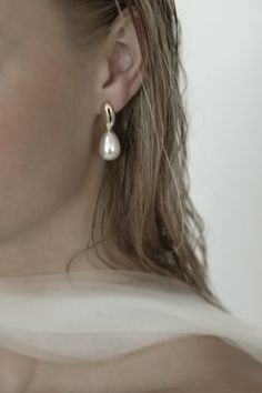 a close up of a person wearing earrings