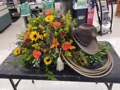 a cowboy hat sits on top of a bouquet of flowers