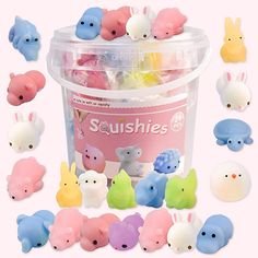 small plastic toy animals in a bucket on a pink background with the words sushies written above them