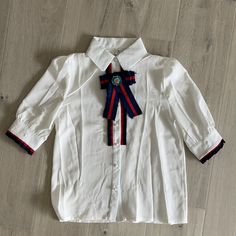 Gucci Style Looking Blouse With A Brooch. Buttons Are Plastic. Never Worn. No Brand Name Size Listed As Small Looks Like It’s Made Of Polyester Material Armpit To Armpit 17.5 Inches Length 24 **** Selling Skirt Separately**** Elegant White Top With Ribbon, Elegant White Tops With Ribbon, Classic White Tops With Bow, Classic White Blouse With Bow, White Bow Blouse For Work, White Bow Blouse For Workwear, White Collared Top With Bow, White Bow Top For Work, White Bow Tops For Work