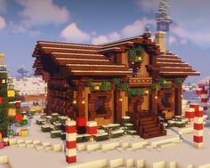 a small wooden house in the middle of a snowy landscape with christmas decorations on it