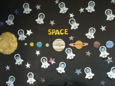 the outer space bulletin board is decorated with paper cut outs