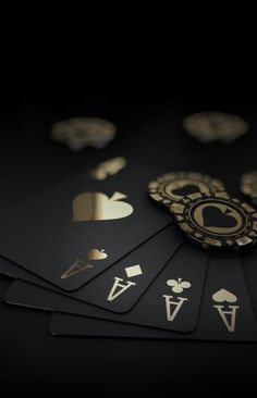 playing cards with gold foil on them are arranged in the shape of spades and hearts