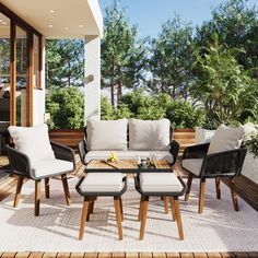 an outdoor living room with furniture and plants on the deck area, including chairs and tables