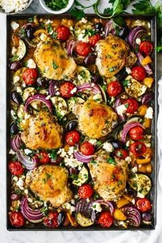 an overhead shot of chicken and vegetables on a baking sheet, with other ingredients in the background