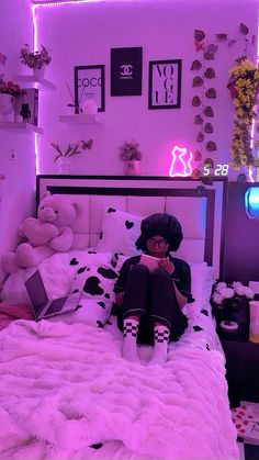 a woman sitting on top of a bed in a room with stuffed animals and decorations