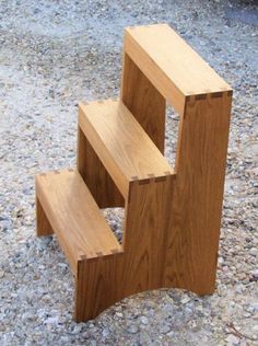 three wooden steps sitting on top of gravel