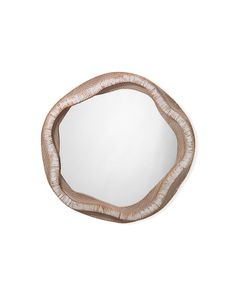 a mirror that is sitting on top of a white wall and it has a circular shape