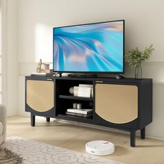 a flat screen tv sitting on top of a wooden entertainment center in a living room