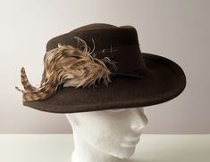 Vintage 80s Chocolate brown women's fedora, felt wool hat with feather, ladies hat with ribbon, gift idea for her, formal accessories, wide brim hat Hat is in good vintage condition, makes a great gift for a hat collector/lover! Size:  Inside circumference - 21.25" Condition: Great vintage condition SHIPPING * I ship worldwide via Priority mail (Latvijas Pasts) from Latvia (EU). * I ship from Europe, so please allow 2 to 4 weeks for the package to arrive if you live overseas. * Europe 5 - 10 bus Luxury Brown Cloche Hat With Short Brim, Classic Luxury Brown Hat, Luxury Brown Cloche Hat With Curved Brim, Luxury Brown Felt Hat, Luxury Brown Traditional Hat, Luxury Artisan Brown Hat, Luxury Vintage Brown Top Hat, Luxury Brown Fedora For Country Events, Luxury Brown Felt Hat With Short Brim