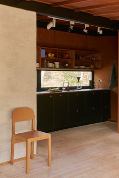 a kitchen with wooden floors and cabinets in it