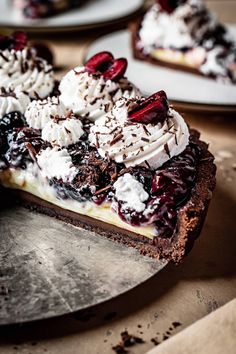 a piece of pie with whipped cream and cherries on top