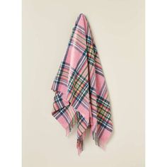 a pink and black plaid blanket hanging on a wall